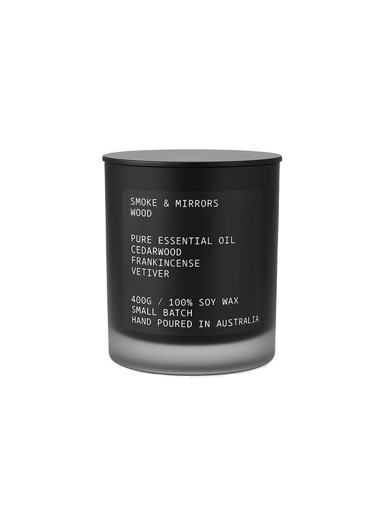 Black candle with white text on a white background